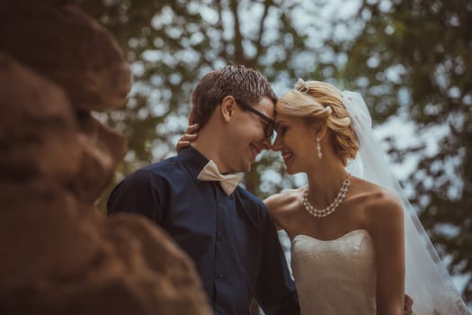 Beautiful young bride and groom in a park