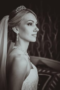 bride in a beautiful dress near the window
