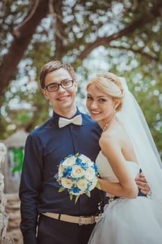 Beautiful young bride and groom in a park