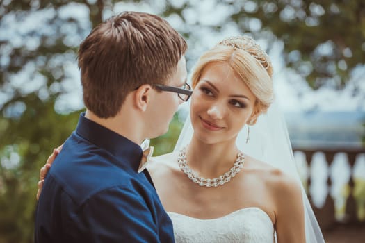 Beautiful young bride and groom in a park