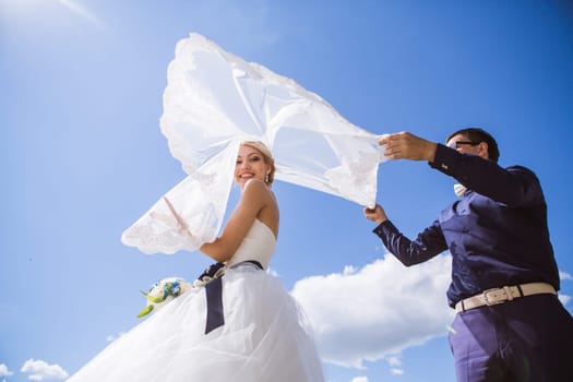 Newly wed couple dancing next to a lake