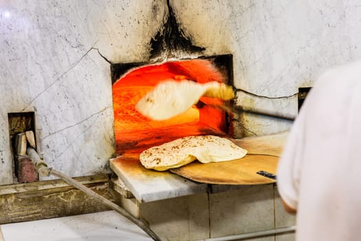Baking traditional arabic flatbread at a bakery in Dubai's Old Town