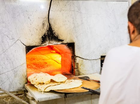 Baking traditional arabic flatbread at a bakery in Dubai's Old Town
