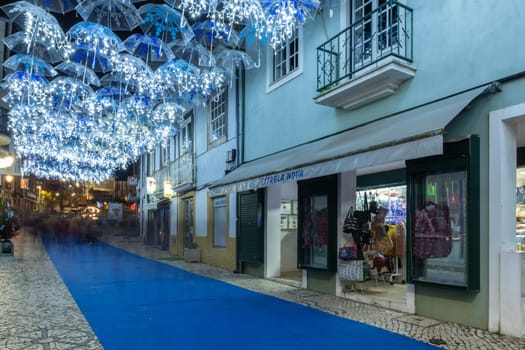 AGUEDA, PORTUGAL - CIRCA DECEMBER 2018: The beauty of white umbrellas iluminated by Christmas lights decorating the streets of Agueda Portugal