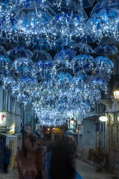 The beauty of white umbrellas iluminated by Christmas lights decorating the streets of Agueda Portugal