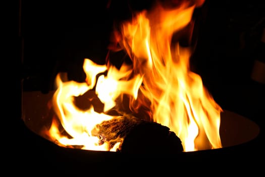 Detail of a log burning in a hunters campfire.