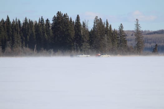 Two Fisherman Fishing in the Distance on a Windy Lake.