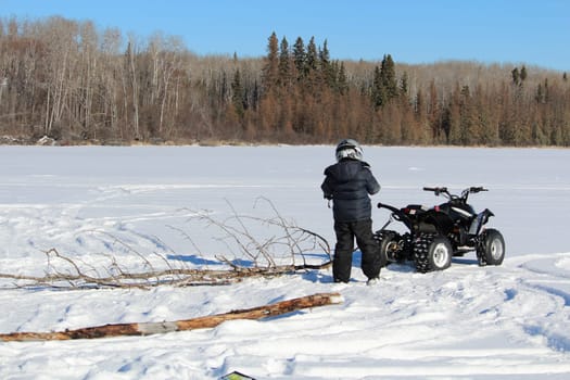 Pulling Firewood With a Quad to Make a Fire on the Ice.