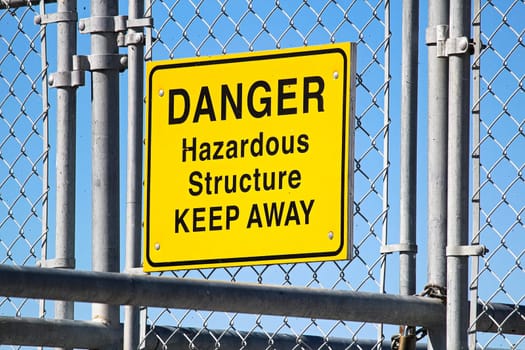 A Danger Hazardous Structure Keep Away sign.