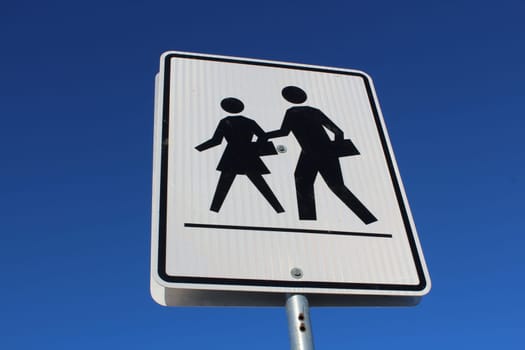 Crosswalk Sign Against Blue Sky