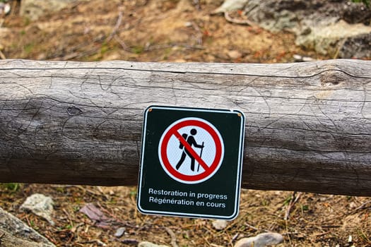 Restoration in progress signs on temporarily closed trails.