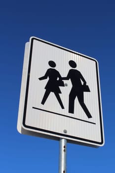 Crosswalk Sign Against Blue Sky