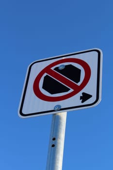 No Stopping Right of Sign Against Blue Sky.