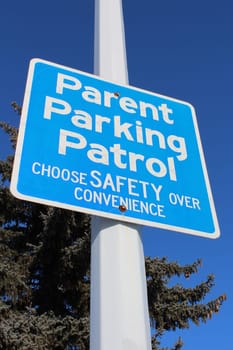 Parent Parking Patrol Sign Against Tree and Blue Sky