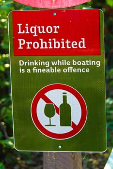 A liquor prohibited, drinking while boating is an offense sign.