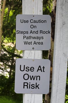 Use caution on steps and rocks sign.