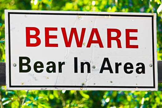 a white beware bear in area sign.