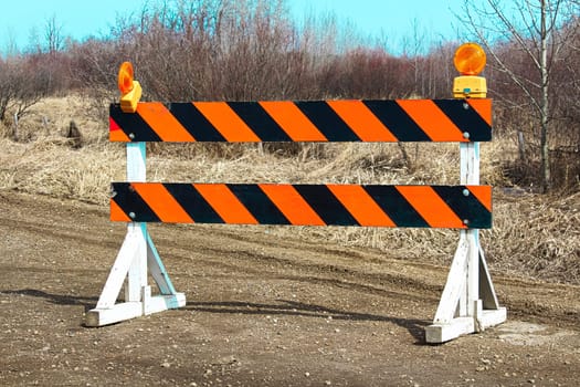 Construction barricade along a country road.
