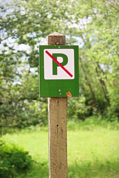Closeup of a green no parking sign.