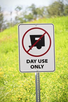Closeup of a day use only sign.