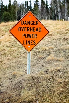 Danger overhead powerline sign in the country.