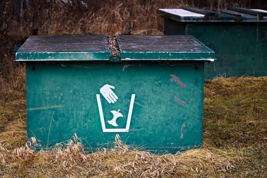Closeup of two garbage bins in a campground.