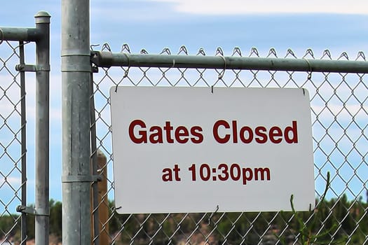 Gate closes at 10:30 pm sign at a beach.