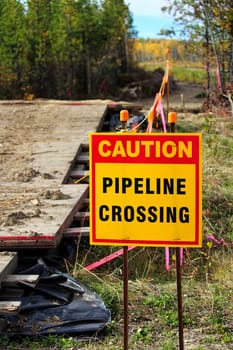 Closeup of a caution pipeline crossing sign.
