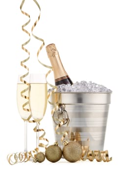 Still life with cooled champagne bottle standing in a bucket with ice, two full champagne flutes and Christmas ornaments isolated on a white background, Christmas and New Year celebration