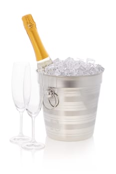 Champagne bottle is cooling in a bucket with ice isolated on a white background