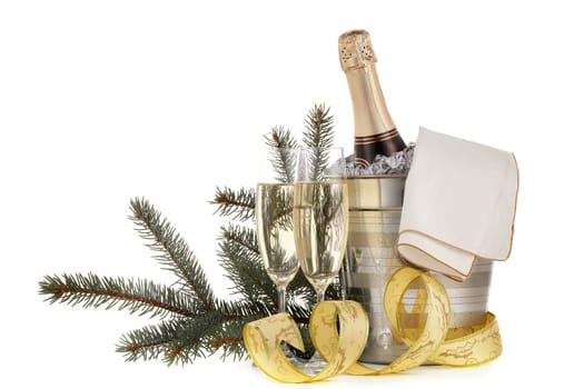 Still life with champagne bottle standing in a bucket with ice, two full champagne flutes and Christmas ornaments isolated on a white background with copy space, Christmas and New Year celebration