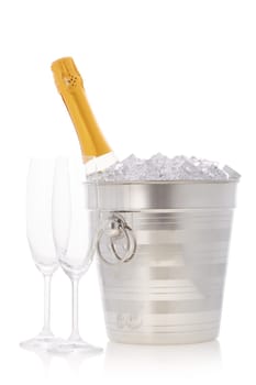 Champagne bottle is cooling in a bucket with ice isolated on a white background