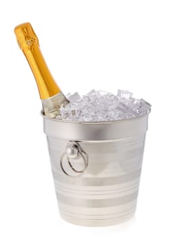 Champagne bottle is cooling in a bucket with ice isolated on a white background