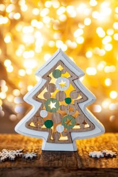Cheerful little Christmas tree in front of bokeh lights