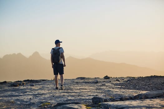 Young tourist hiking in mountain at sunset. Jebel Akhdar, Oman.