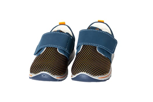 Child shoe fashion. A pair of blue denim child sneaker or sport shoes isolated on a white background. Elegant and trendy shoes.