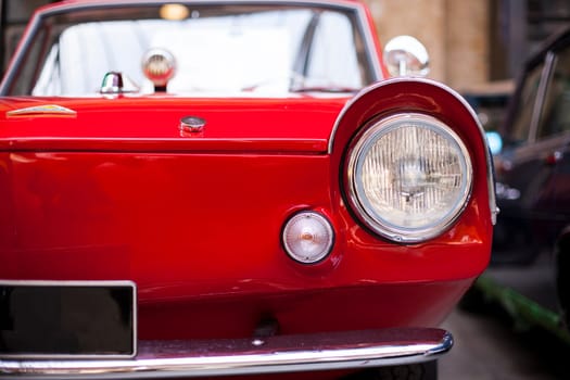 Classic vintage car. Close-up of headlights of luxurious vintage vehicle