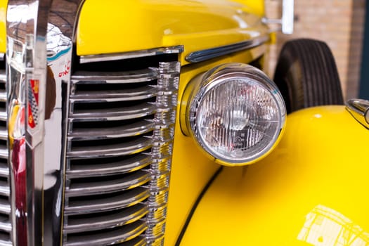 Classic vintage car. Close-up of headlights of luxurious vintage vehicle