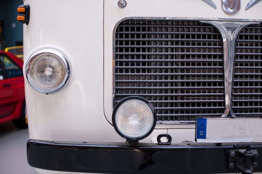 Classic vintage car. Close-up of headlights of luxurious vintage vehicle