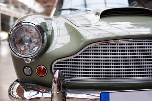 Classic vintage car. Close-up of headlights of luxurious vintage vehicle