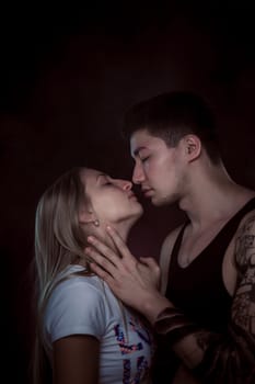 Shot of a passionate loving couple. Over black background.