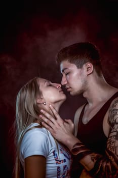 Sexy passion couple, beautiful young man and woman closeup, studio shot