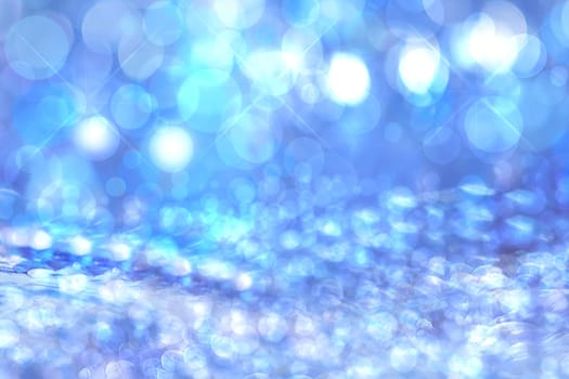 Abstract blurred festive blue background  for winter Christmas with bokeh defocused blue lights.