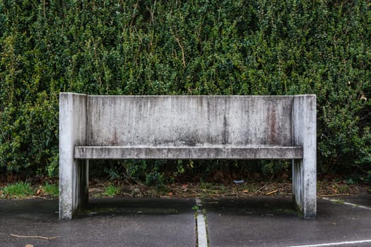 Stone Bench Grungy Against Green Bush Leaves Background Closeup Sit Empty Surface Dirty Cement Concrete Geometric Rectangular Outdoors