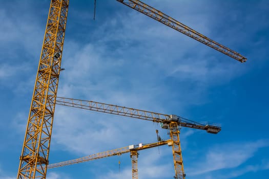 Blue Sky Over Construction Cranes Yellow Diagonal Copyspace Building Architecture Working Operation Frame Metal