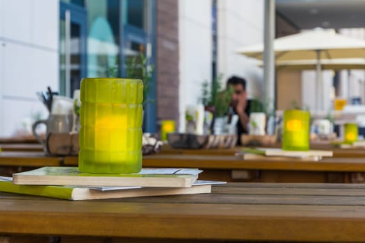 Green Glass Candle Restaurant Table Depth of Field Daytime Outdoors