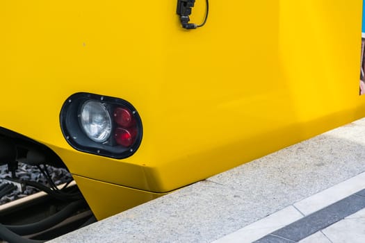 Subway Train Headlight Arriving Red White Light Daytime Yellow Side Abstract Bright Concrete Platform Closeup Detail Copyspace