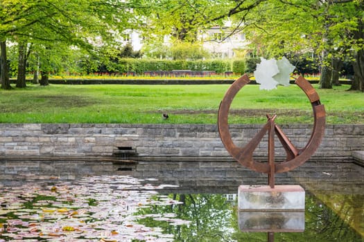 Germany Country Shape Statue Art Decoration in Spring Park Green Grass Water Reflection