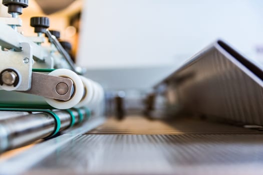 Paper Folding Machine Transfer Wheels Rollers Print Production Letter Sheet Moving Screws Adjustments Closeup