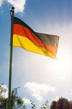 German Flag Black Red Gold Patriotic Symbol on Blue Sky Background